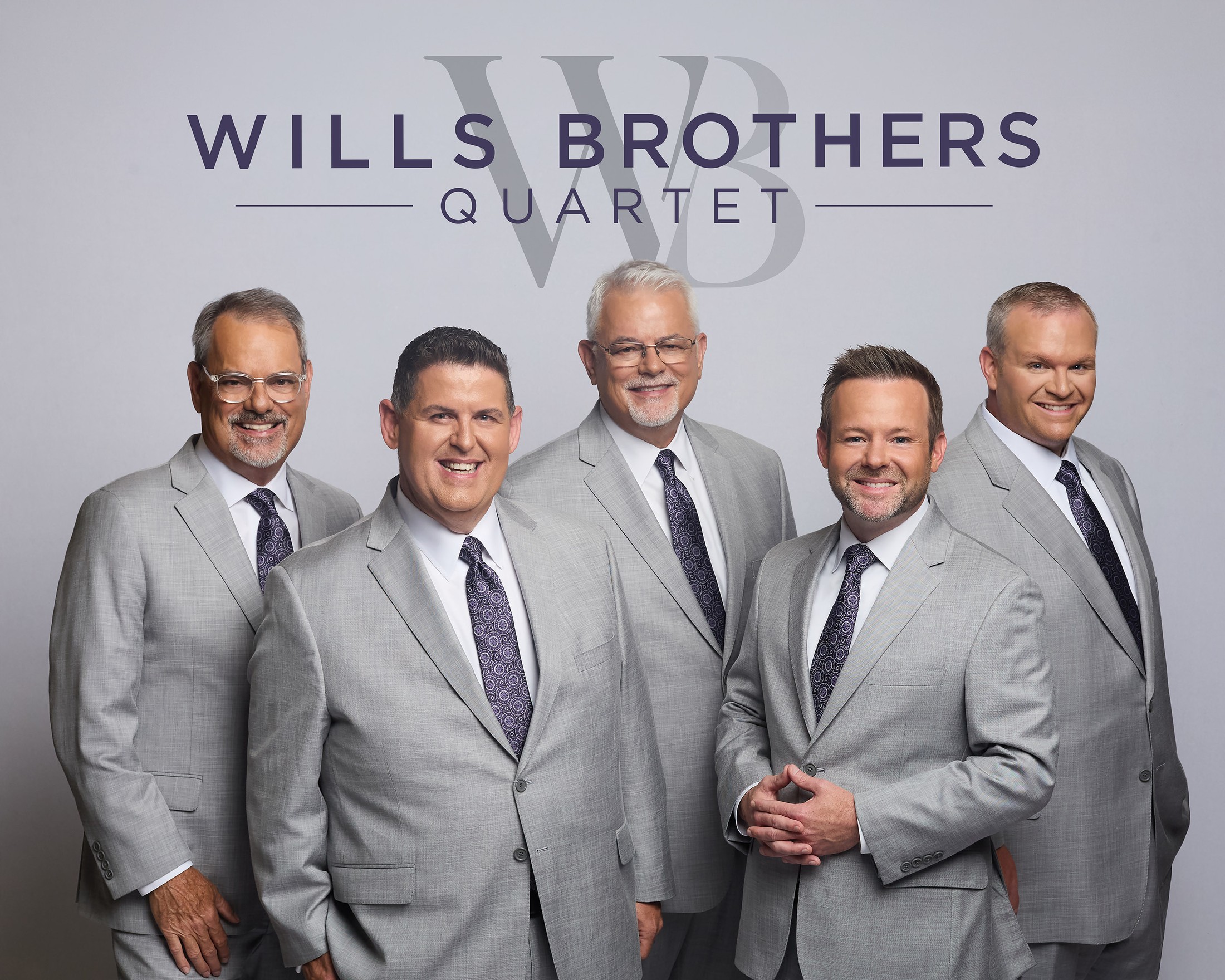 The five members of Wills Brothers Quartet — formerly The Inspirationals Quartet of Texas — standing together in matching suits beneath the Wills Brothers Quartet logo
